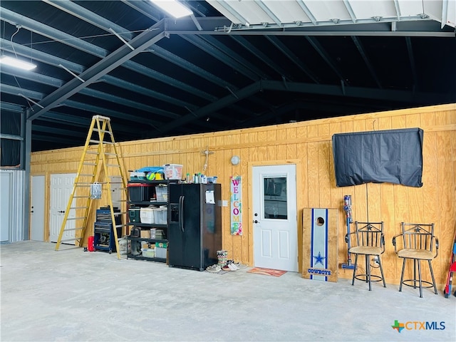 garage with black fridge