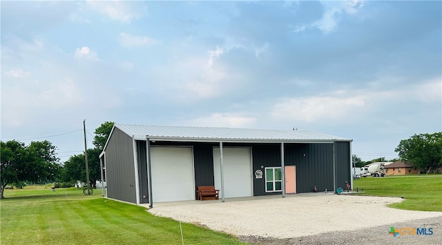 back of property featuring an outbuilding, a lawn, and a garage