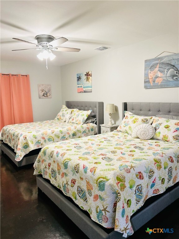 bedroom featuring concrete flooring and ceiling fan