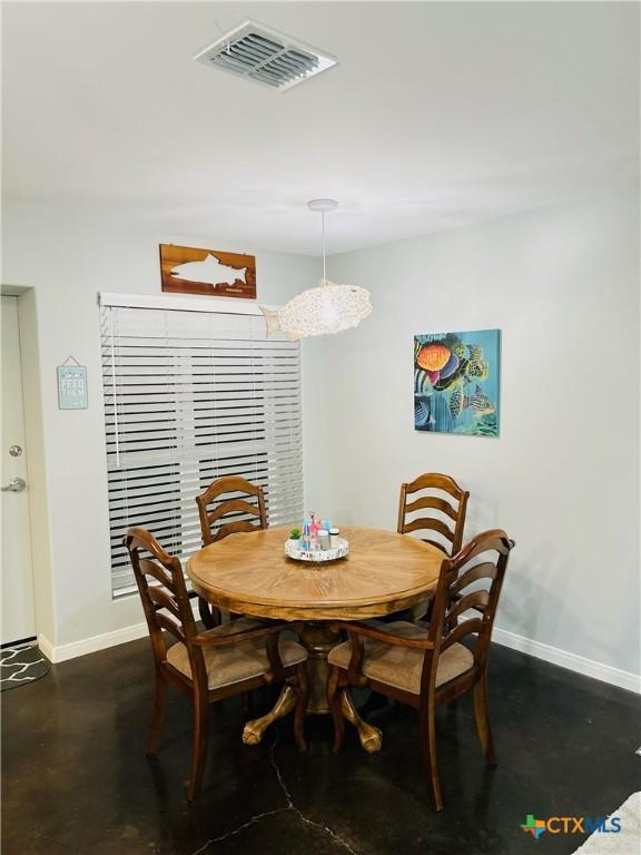 305 W Denver Ave, Seadrift, TX 77983 - dining space with baseboards and concrete floors