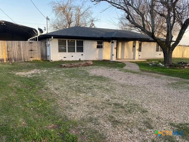 single story home with a front lawn, fence, and crawl space