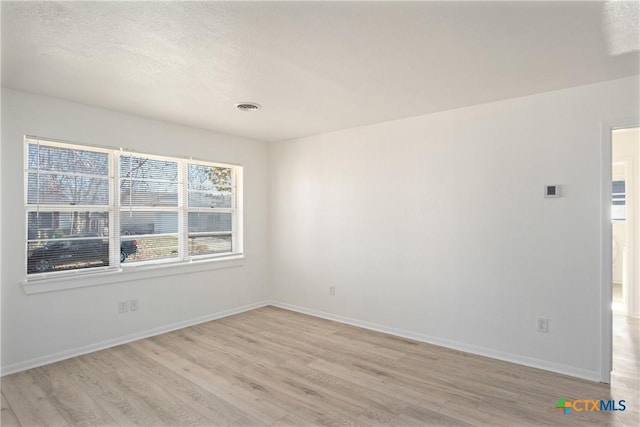 empty room with light hardwood / wood-style floors