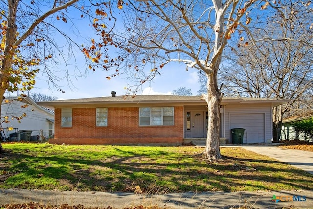 ranch-style home with a garage and a front lawn