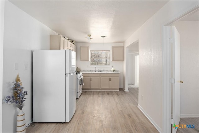 kitchen with light wood-type flooring and white appliances