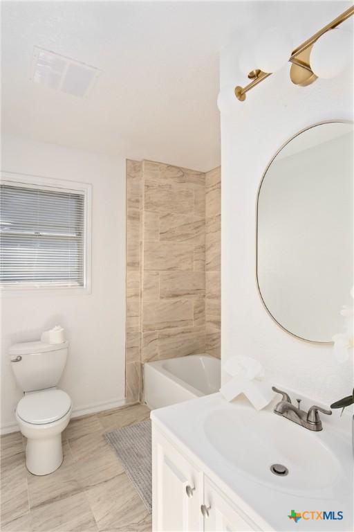 full bathroom featuring tile patterned floors, vanity, toilet, and shower / washtub combination