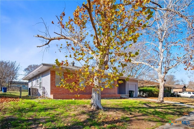 ranch-style home with a garage and a front yard