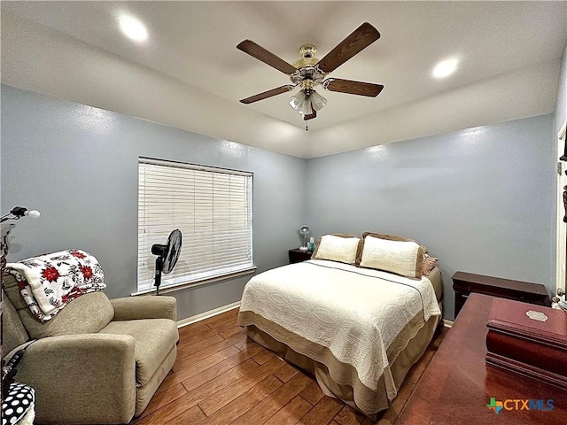 bedroom featuring recessed lighting, wood-type flooring, a ceiling fan, and baseboards