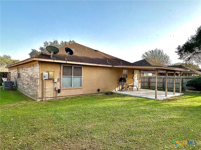 back of house featuring a patio, a lawn, central AC unit, and fence