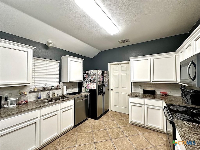 kitchen with a sink, refrigerator with ice dispenser, visible vents, stainless steel dishwasher, and black electric range oven