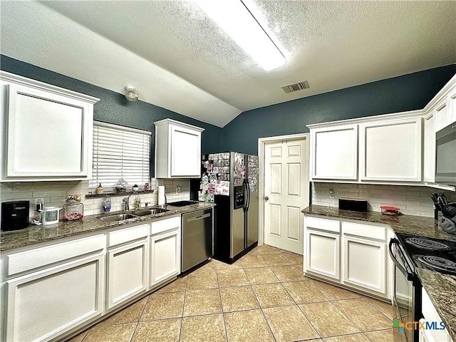 kitchen with tasteful backsplash, visible vents, white cabinets, black appliances, and a sink