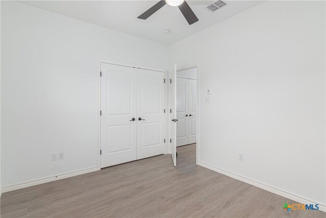 168 Navarro Xing, Seguin, TX 78155 - unfurnished bedroom featuring wood finished floors, baseboards, and a ceiling fan