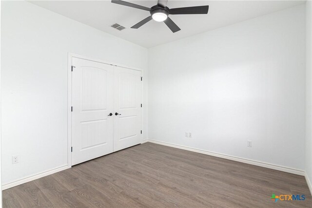 168 Navarro Xing, Seguin, TX 78155 - unfurnished bedroom with wood finished floors, baseboards, a closet, and ceiling fan