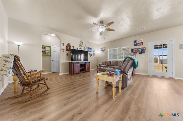 living room with ceiling fan and light hardwood / wood-style floors