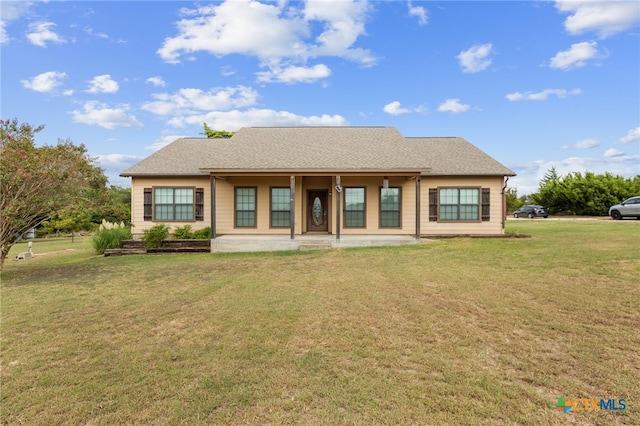 rear view of property featuring a lawn