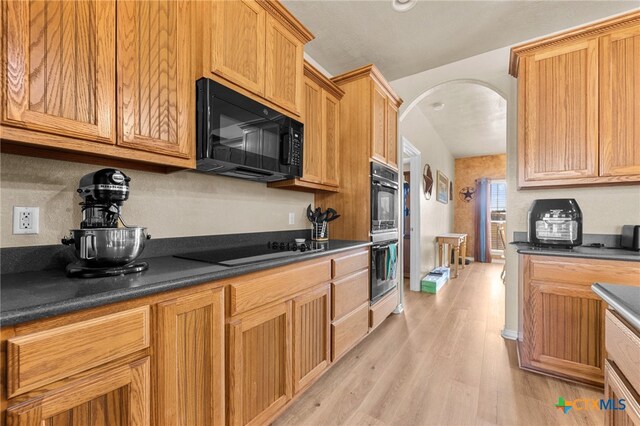 kitchen with black appliances and light wood-type flooring