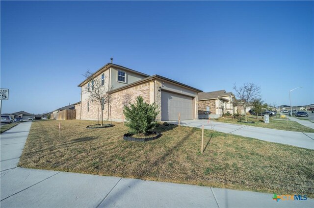 630 Golden Grove Pkwy, San Marcos, TX 78666 - view of front facade with brick siding, driveway, an attached garage, and a front lawn