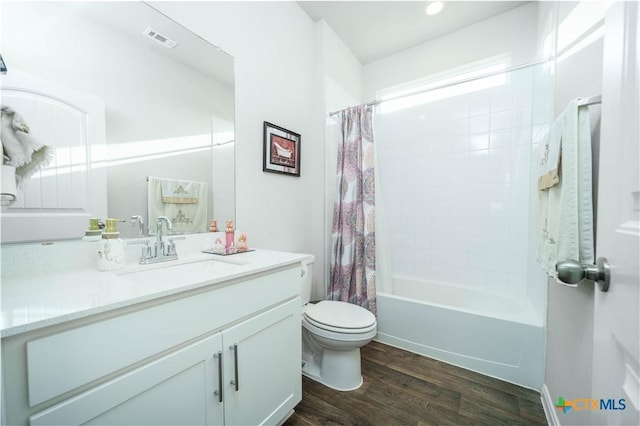 630 Golden Grove Pkwy, San Marcos, TX 78666 - bathroom with vanity, wood finished floors, visible vents, shower / bath combo with shower curtain, and toilet