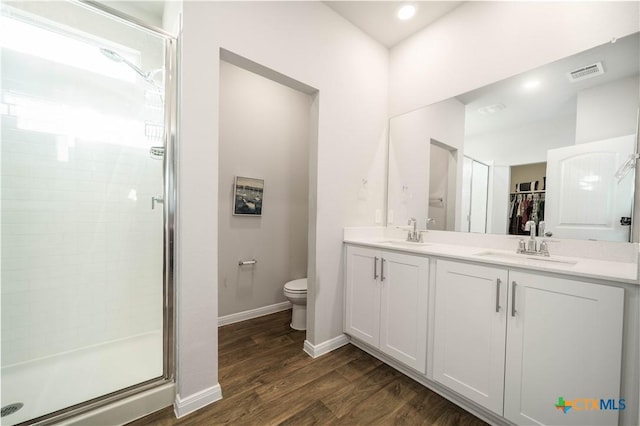 630 Golden Grove Pkwy, San Marcos, TX 78666 - bathroom featuring visible vents, a stall shower, toilet, and wood finished floors