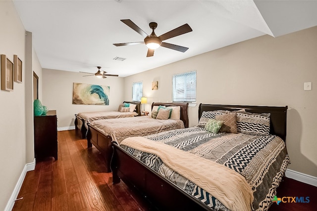 bedroom featuring baseboards, wood-type flooring, a ceiling fan, and visible vents