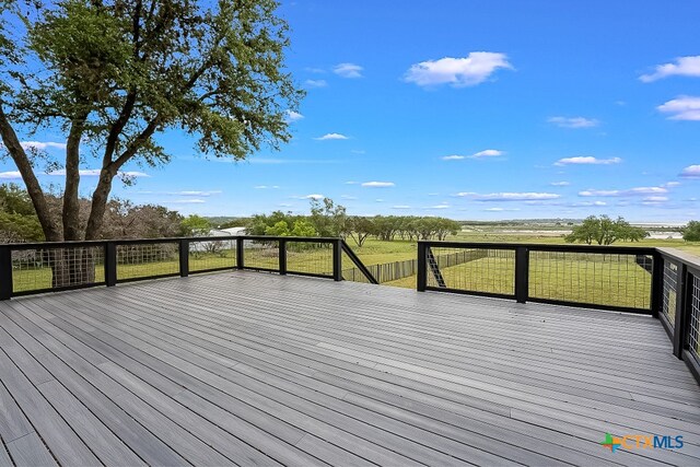 wooden terrace featuring a rural view