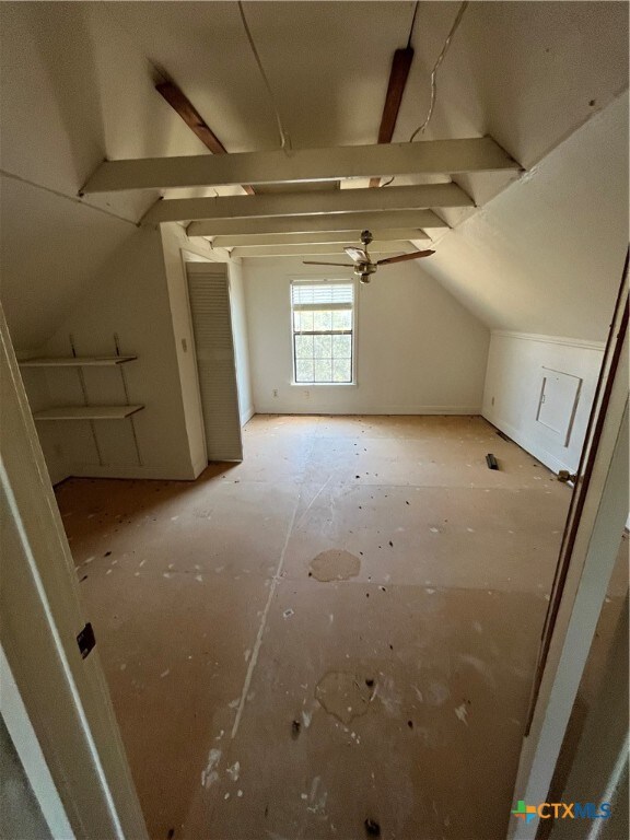 additional living space with ceiling fan and vaulted ceiling