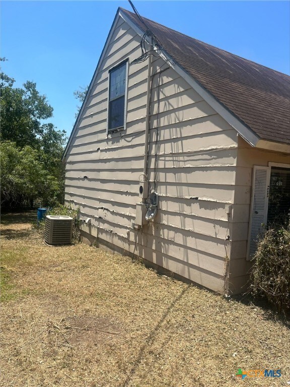 view of side of property with central AC