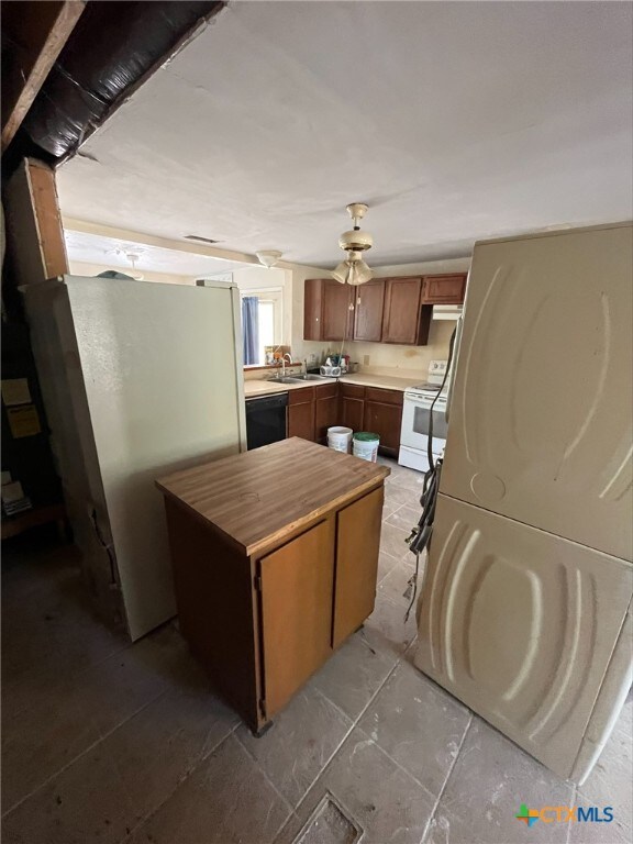 kitchen with white appliances, wood counters, and sink