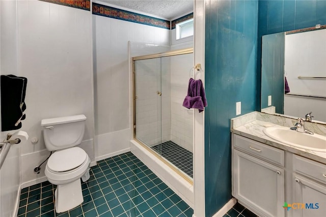 925 Eden Roc St, Victoria, TX 77904 - full bathroom with a shower stall, vanity, a textured ceiling, and tile patterned floors