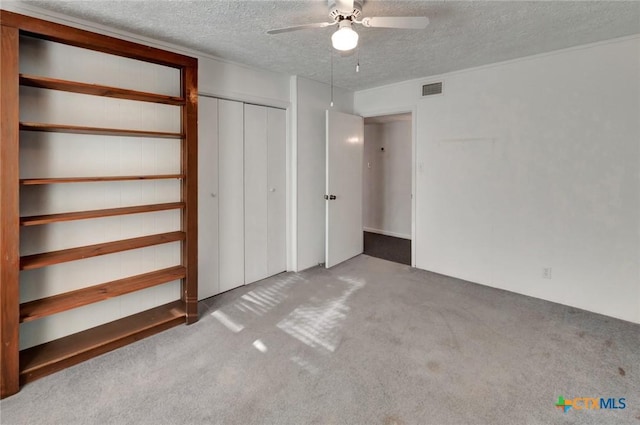925 Eden Roc St, Victoria, TX 77904 - unfurnished bedroom with a textured ceiling, carpet, ceiling fan, and a closet