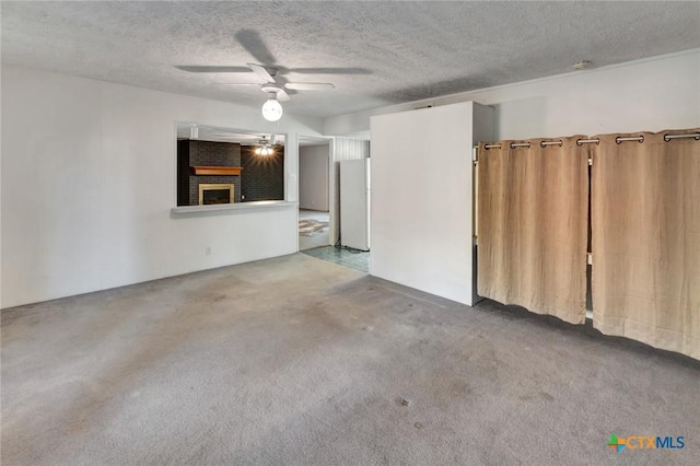925 Eden Roc St, Victoria, TX 77904 - unfurnished living room featuring carpet flooring, a textured ceiling, and a ceiling fan