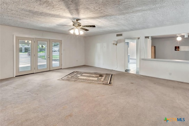 925 Eden Roc St, Victoria, TX 77904 - empty room with carpet flooring, a textured ceiling, french doors, and ceiling fan