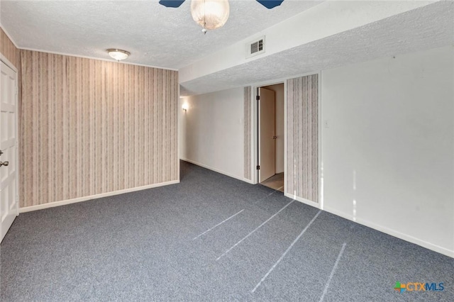 925 Eden Roc St, Victoria, TX 77904 - spare room with a textured ceiling and dark carpet