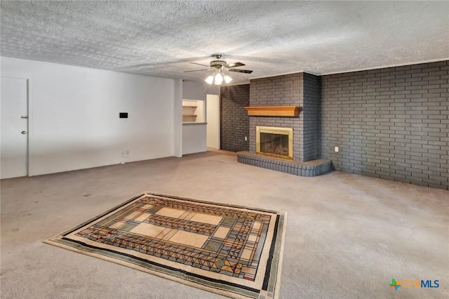 925 Eden Roc St, Victoria, TX 77904 - unfurnished living room with carpet, a ceiling fan, a textured ceiling, a brick fireplace, and brick wall