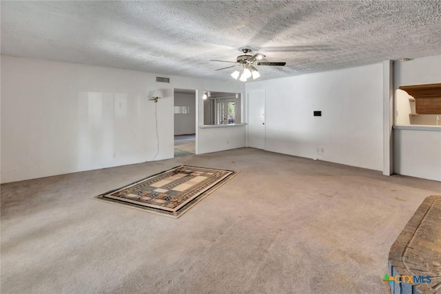 925 Eden Roc St, Victoria, TX 77904 - unfurnished living room with carpet flooring, a ceiling fan, and a textured ceiling