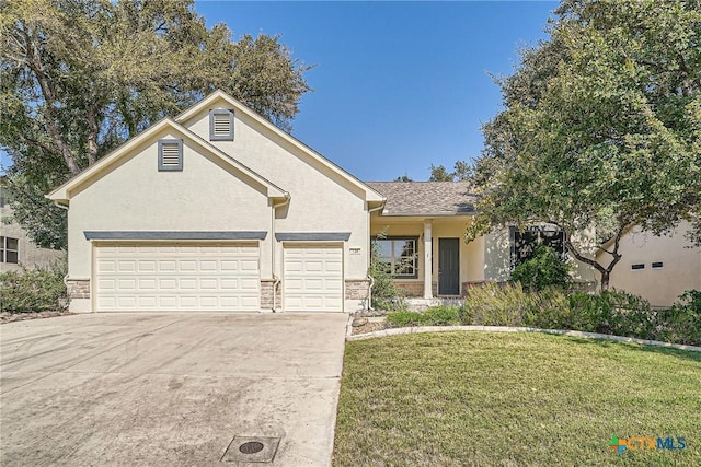 view of front facade with a garage and a front lawn