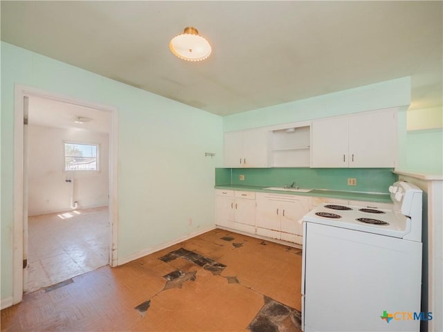 kitchen featuring white range with electric cooktop, white cabinets, and sink