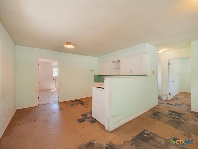 kitchen featuring white cabinets and washer / clothes dryer