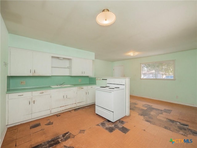 kitchen with white cabinetry, electric range, and sink