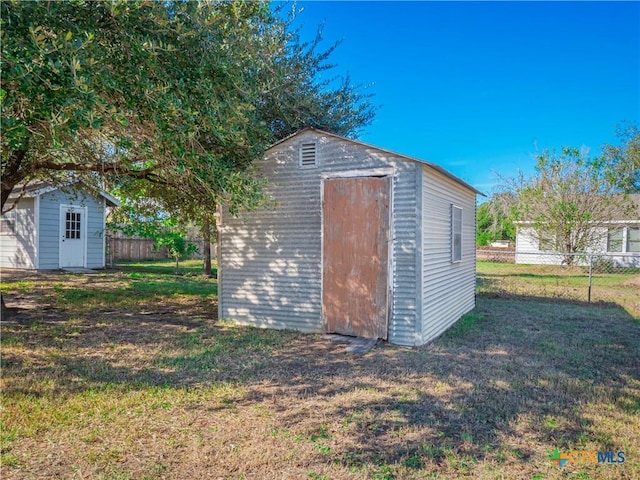 view of outbuilding featuring a lawn