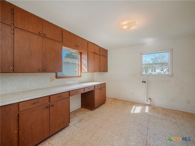 kitchen featuring tasteful backsplash and built in desk