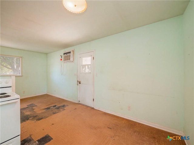 kitchen with a wall mounted AC and white electric stove