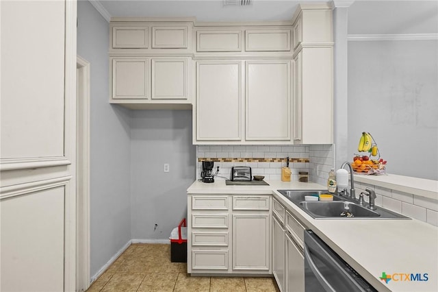 214 Belmoor Ln, Victoria, TX 77904 - kitchen with backsplash, stainless steel dishwasher, light countertops, ornamental molding, and light tile patterned floors