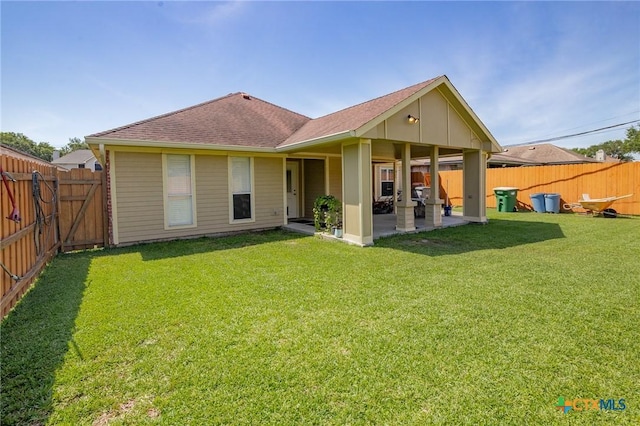 214 Belmoor Ln, Victoria, TX 77904 - back of property with a patio, a fenced backyard, and roof with shingles