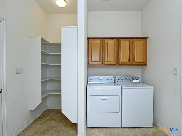 laundry room with cabinets and washer and clothes dryer