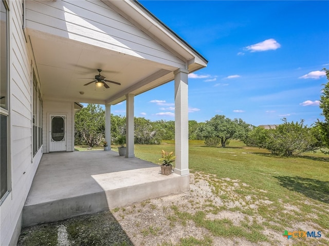 view of yard featuring a patio area and ceiling fan