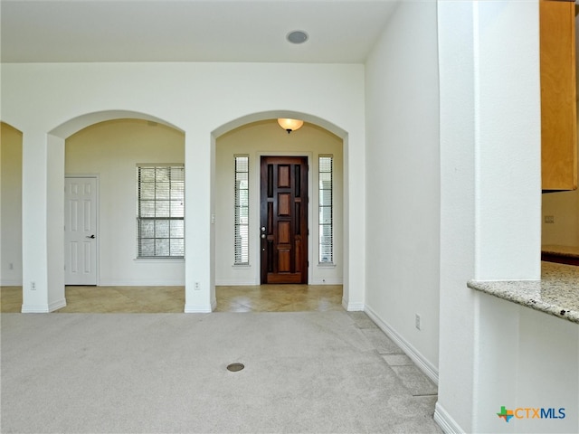 view of carpeted foyer