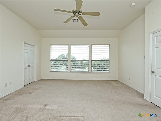 unfurnished room with lofted ceiling, light carpet, and ceiling fan