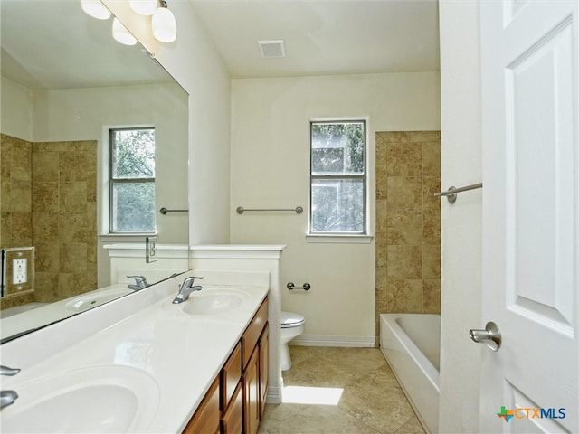 full bathroom featuring toilet, vanity, tile patterned flooring, and plenty of natural light