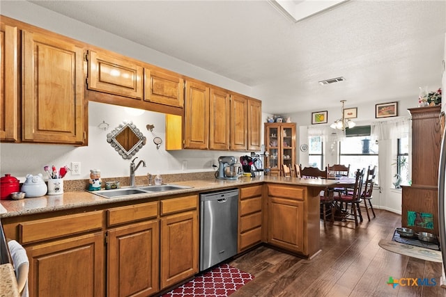 kitchen with dark hardwood / wood-style floors, pendant lighting, dishwasher, sink, and kitchen peninsula