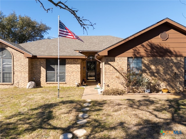 ranch-style house with a front lawn